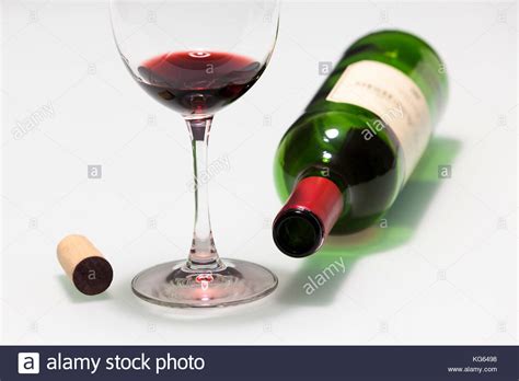 Cup with some red wine, cork and empty bottle Stock Photo - Alamy