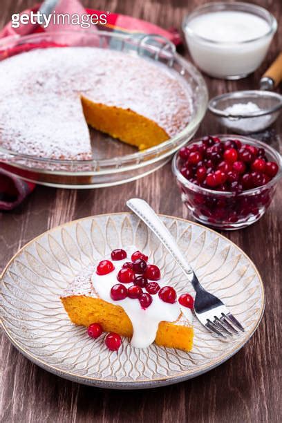 Piece of Swedish saffron Kladdkaka pie on a wooden plate vertical 이미지