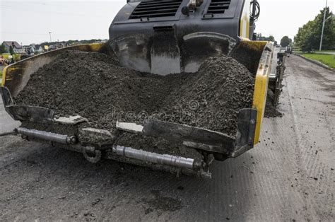 Asphalt Paver Machine during Road Construction and Repairing Works. a ...