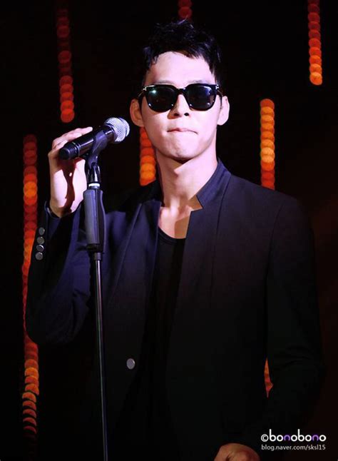 A Man With Sunglasses On Holding A Microphone