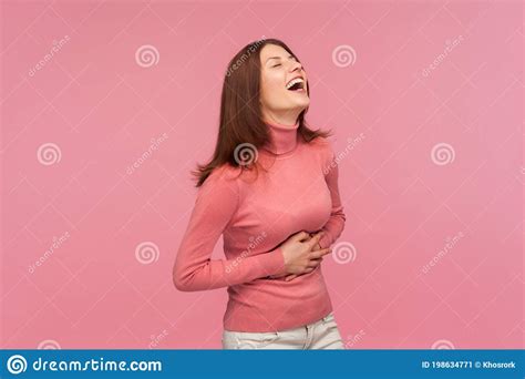 Funny Positive Brunette Woman In Pink Sweater Holding Her Belly And