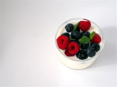 Premium Photo A Glass Of Yogurt With Fresh Raspberry And Blueberries