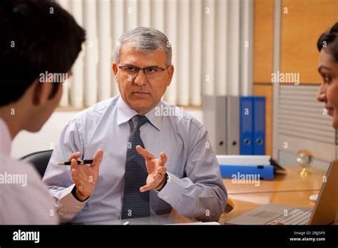 Manager Wearing Formals Explaining To His Employees Stock Photo Alamy