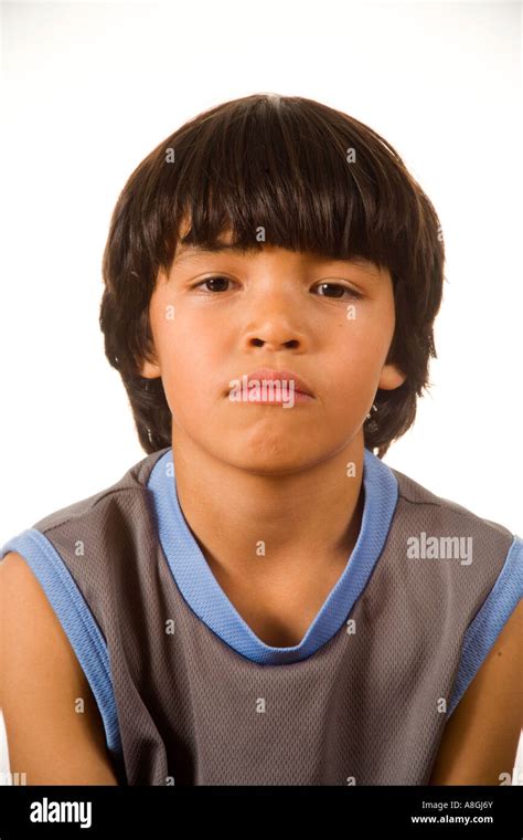 An 8 Year Old Chinese American Boy Wears A Contemplative Demeanor At