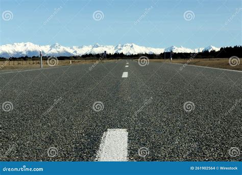 Asphalt Road Leading To The Snowy White Mountains Stock Photo Image