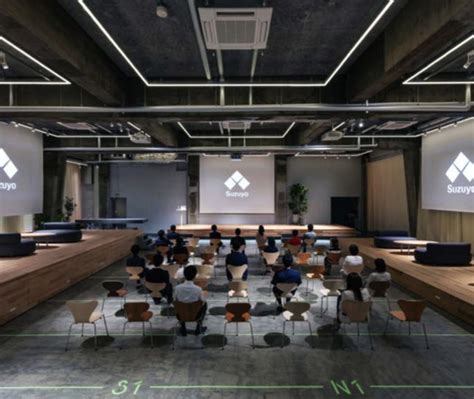 An Empty Conference Room With People Sitting At Desks And Projection