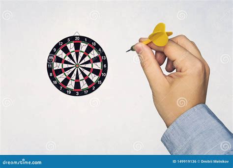 Human Hand Is Throwing The Darts Target To The Darts Board Stock Photo