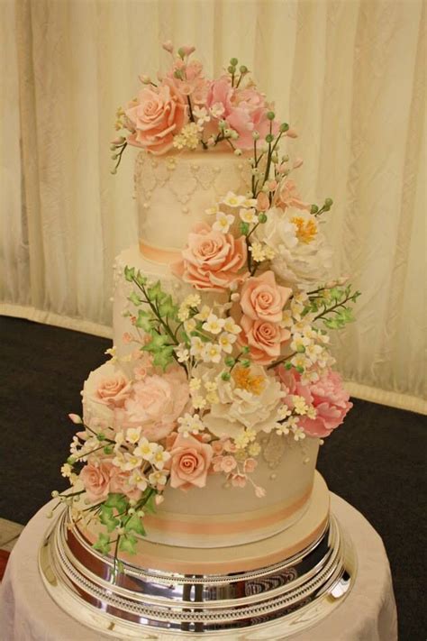 Cascading Peonies Roses And Hydrangea Flowers On A Three Tier Wedding