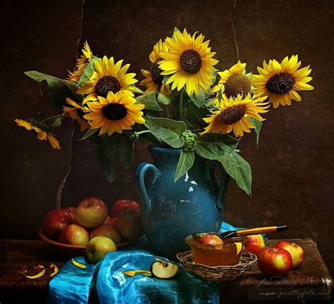 A Painting Of Sunflowers And Apples In A Blue Vase On A Wooden Table