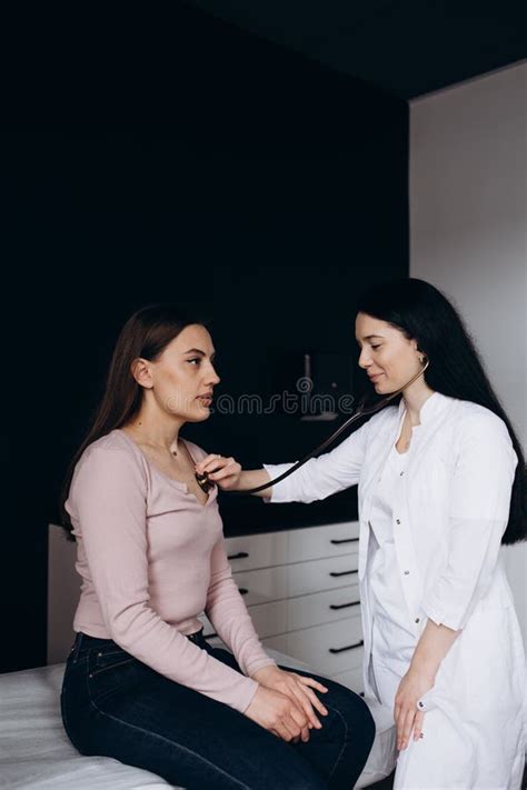 Doctor Listening Stethoscope With To Heart Of Young Female Patient