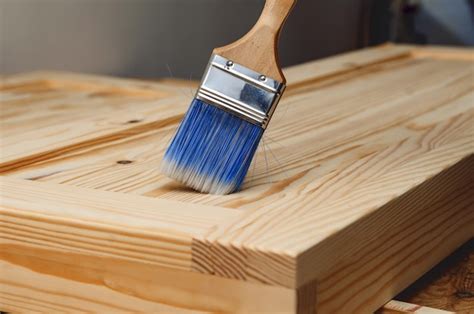 Premium Photo | Painting a wooden surface with a brush