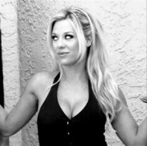 A Black And White Photo Of A Woman With Long Blonde Hair Wearing A Tank Top