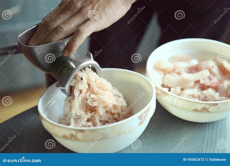 man mincing fish  grinder stock photo image  hand grind