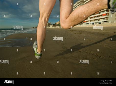 Close up of male runner s feet on beach Stock Photo - Alamy