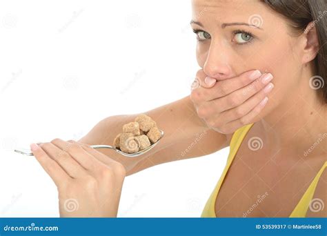 Attractive Cautious Natural Young Woman Holding A Spoonful Of Brown