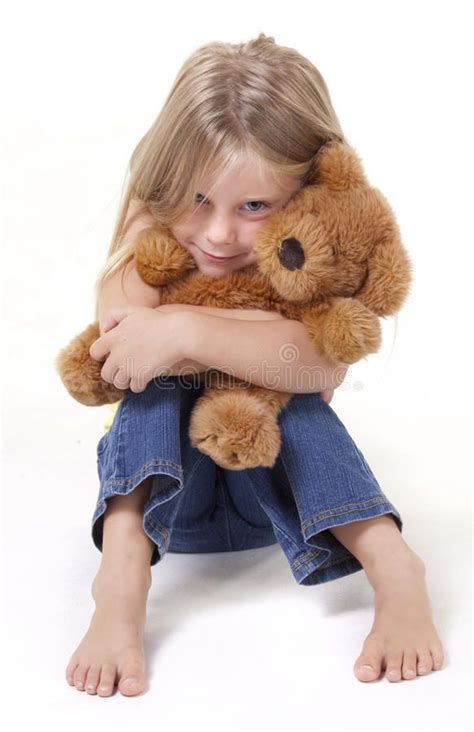 Teddy Bear Hug Girl With Shy Expression With Her Teddy Bear In A Tigh