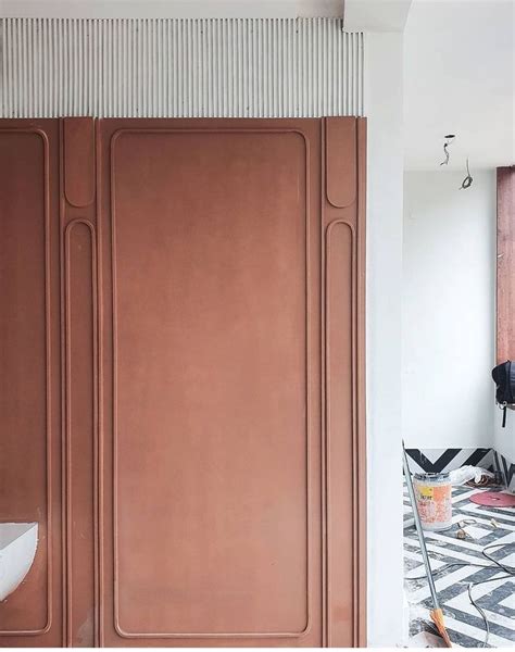 A Bathroom With Pink Walls And Black And White Flooring