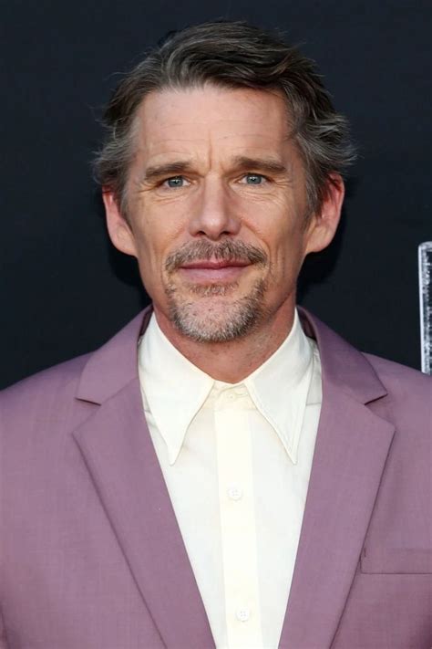 a man in a purple suit and white shirt