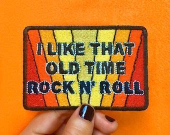 Someone Is Holding Up A Patch That Says I Like That Old Time Rock N Roll