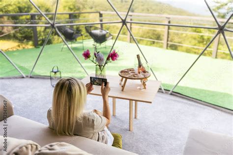 woman in interior of modern luxury glamping tent camp. Eco design ...