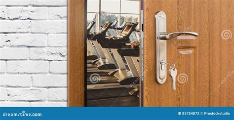 Entrance To Gym In Fitness Club Opened Door With Treadmills Stock