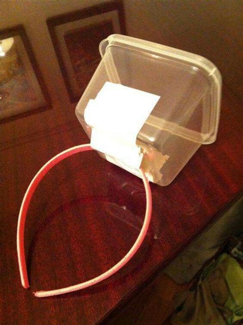 A Plastic Container Sitting On Top Of A Wooden Table Next To A Red Cord