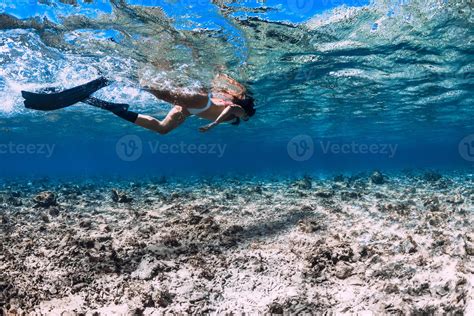 Woman Freediver In Bikini Glides With Fins Over Sandy Sea Freediving