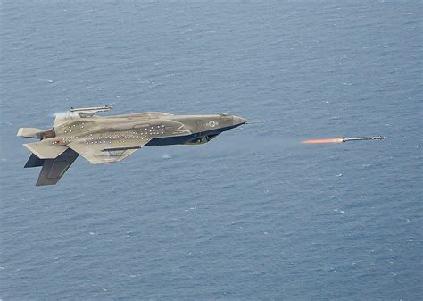 US Navy F-35C Lightning II firing an AIM-9X during inverted flight. Patuxent River Naval Base ...