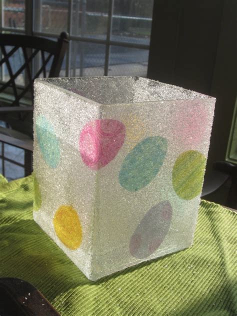 A Square Box Sitting On Top Of A Table Covered In Confetti And Frosting