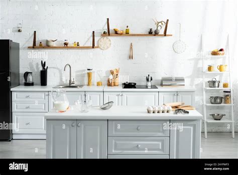 interior of kitchen with cooking utensils, food, milk and kitchenware ...