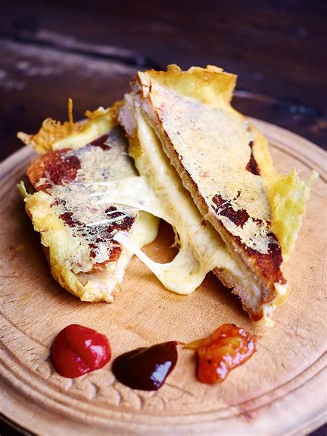 Two Pieces Of Pizza On A Wooden Plate With Ketchup And Mustard Around It