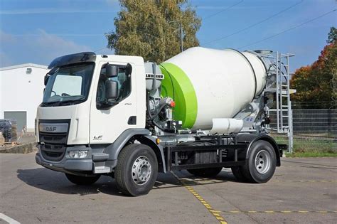 A White And Green Truck Parked In A Parking Lot