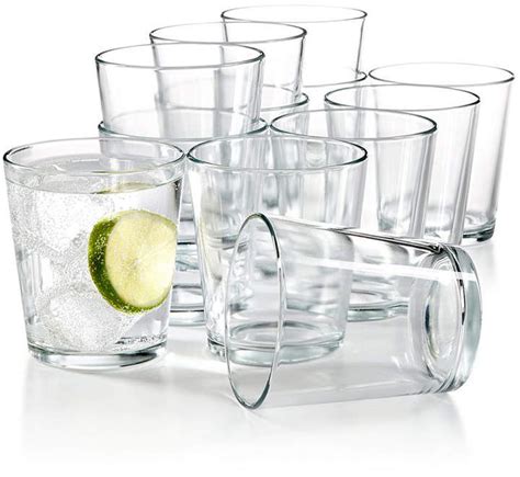 A Set Of Twelve Glasses With Lime Slices And Ice Cubes On The Bottom