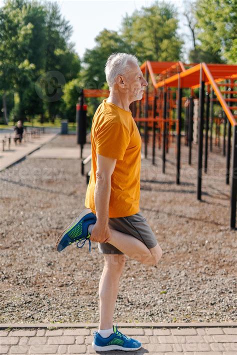 Senior man stretching legs after workout in outdoor gym 51963730 Stock