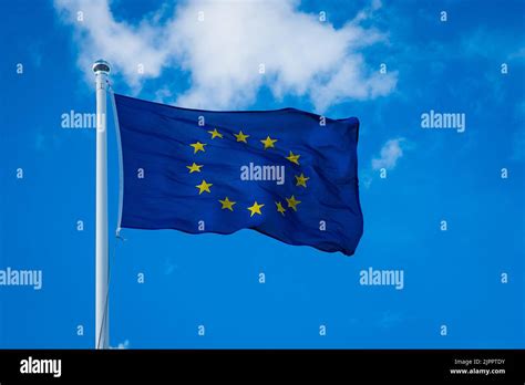 Torn European Flag Fluttering In The Wind At The Flagpole Hi Res Stock