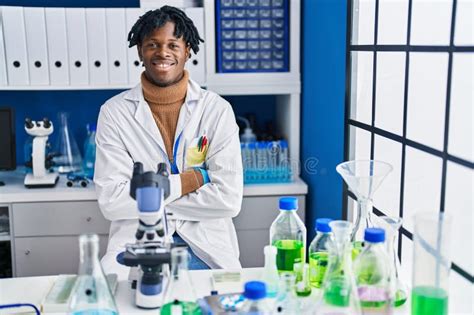 African American Man Scientist Sitting With Arms Crossed Gesture At