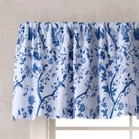 A Blue And White Window Valance With Flowers On The Bottom In Front Of