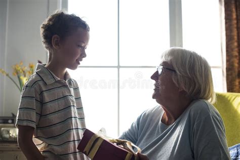 Grandma And Grandson Sitting On The Sofa Together Stock Image Image