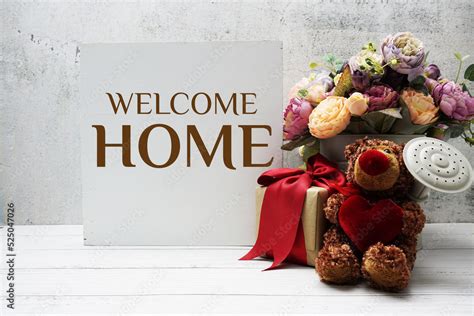 Welcome Home text message with teddy bear and gift boxes present Stock ...