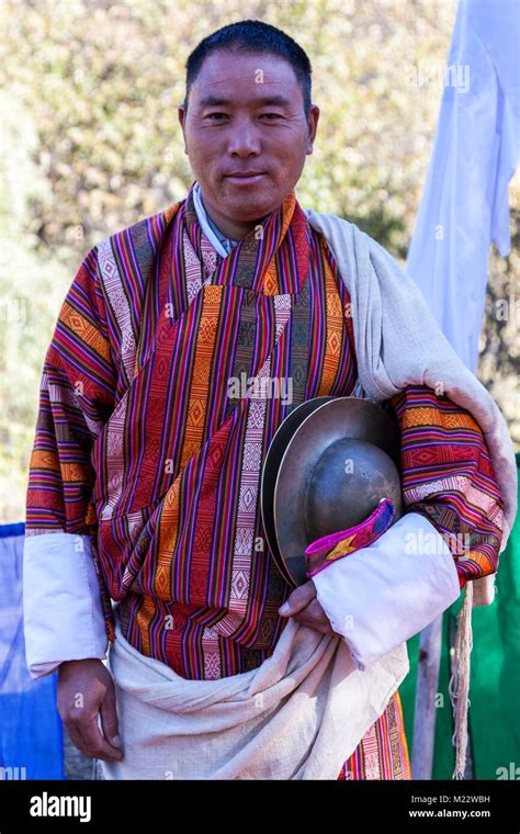 Prakhar Lhakhang Bumthang Bhutan Man Wearing Traditional Gho Holding