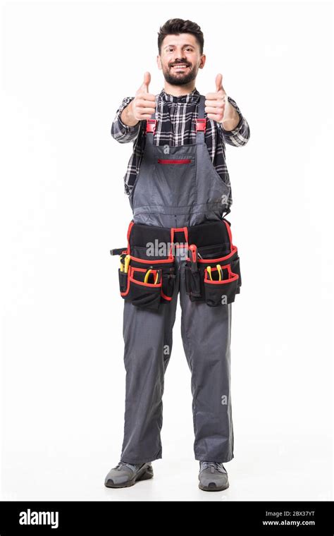 Portrait Of Happy Handyman With Tools Showing Thumbs Up Sign On White