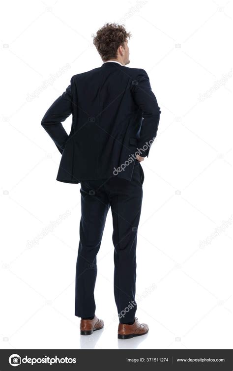 Rear View Hopeful Businessman Holding His Hands On His Waist While Wearing Suit And Standing On