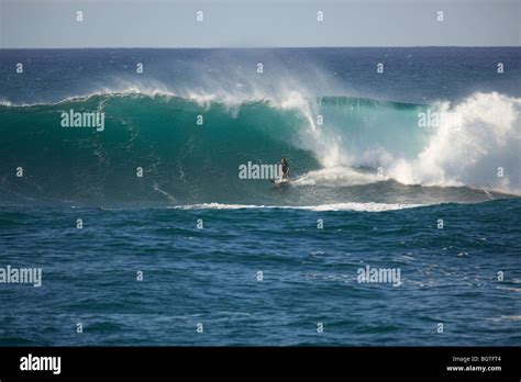 A Surfer Rides A Large Wave At Waimea Bay North Shore Oahu Hawaii