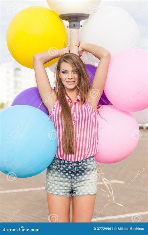 Young Beautiful Lady Holding Bunch Of Bright Balloons Stock Image