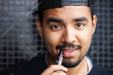 Retrato Del Joven Negro Sonriente Fumando Vaporizador De Cigarrillos