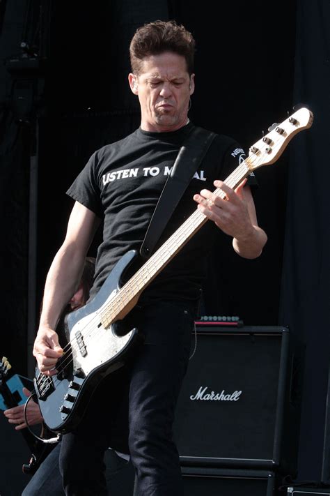 A Man Playing An Electric Guitar On Stage