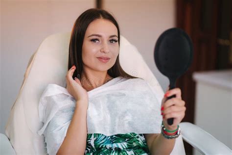 Beautiful Woman In Beauty Salon Looking In The Mirror Stock Image