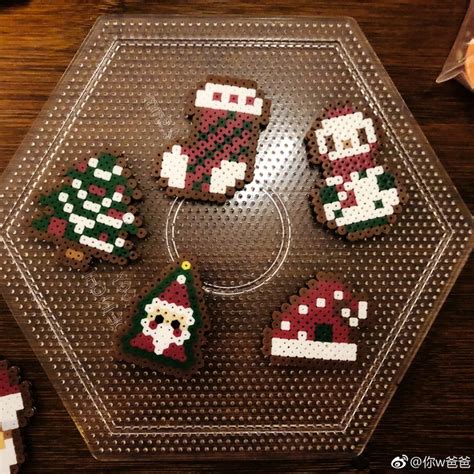 Four Decorated Christmas Cookies Sitting On Top Of A Glass Plate Next