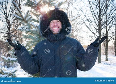 Smiling Man Wearing Fur Hooded Parka Coat In The Winter Park Stock