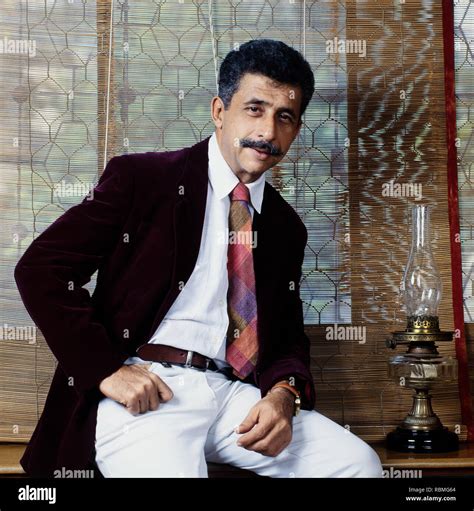 Portrait of Naseeruddin Shah sitting on table, India, Asia Stock Photo ...